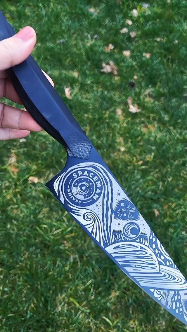 Instagram post by @eatwithme_xyz for Spaceman Knives. Caption reads: [...] #darkmatterart #chefknife #spacemanknives....