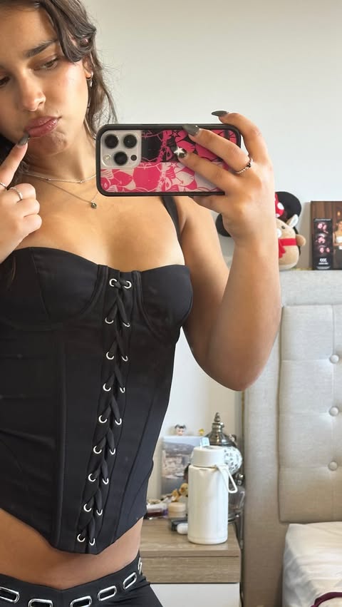 Instagram post by @nataliesmirnakos for Outcast Clothing. Caption reads: [...] regained love for corset tops....