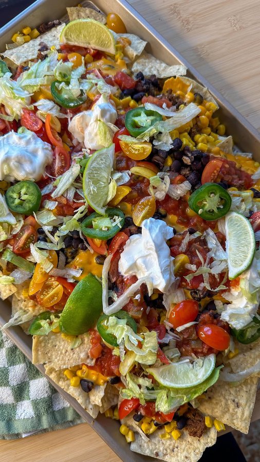 Instagram post by @munchiesbymallory for Tostitos. Caption reads: #AD sheet pan nachos 🌮

Welcome back to my easy....