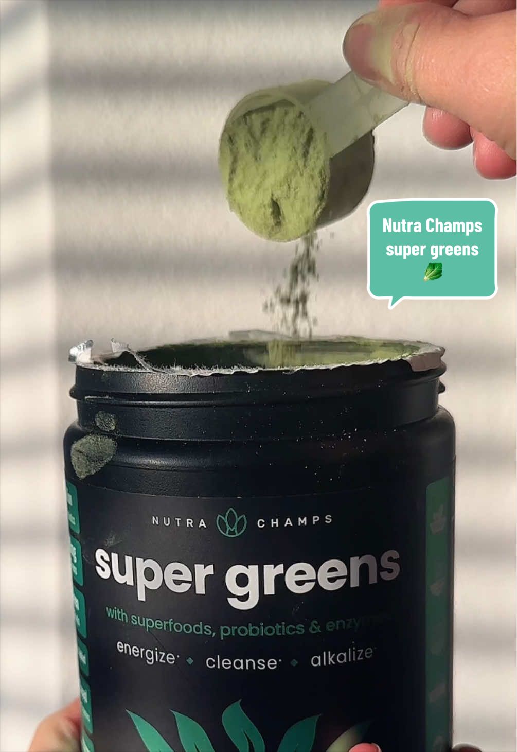 TikTok post by @carolinaflee for NutraChamps. Caption reads: @NutraChamps 🥬✨ #supergreens #drinks #healthy....
