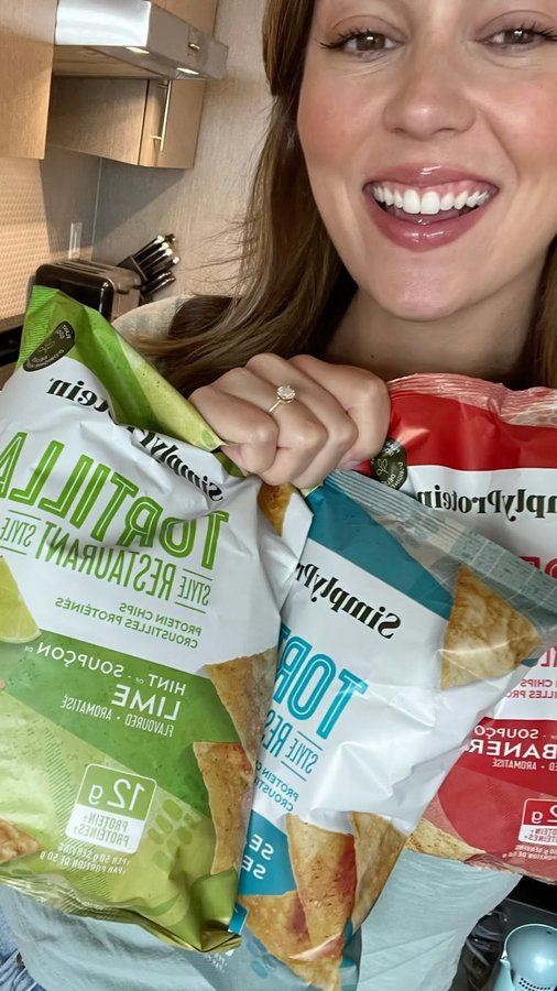Instagram post by @real.life.nutritionist for SimplyProtein. Caption reads: #ad @simplyprotein Protein Tortilla Chips + Greek....