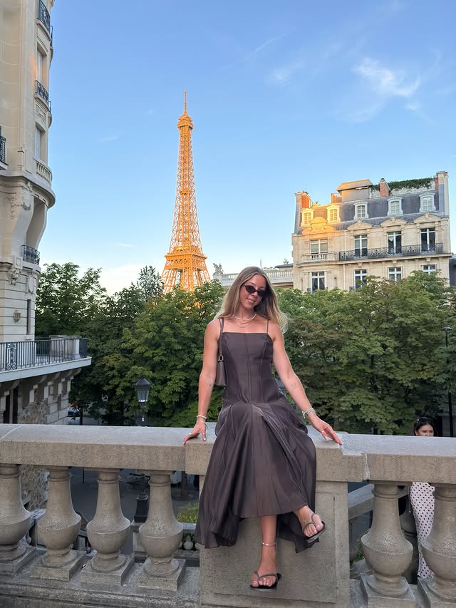 Instagram post by @rhiwanders for NA-KD. Caption reads: [...] forever be unmatched!! 🍷🇫🇷✨🍕 wearing....