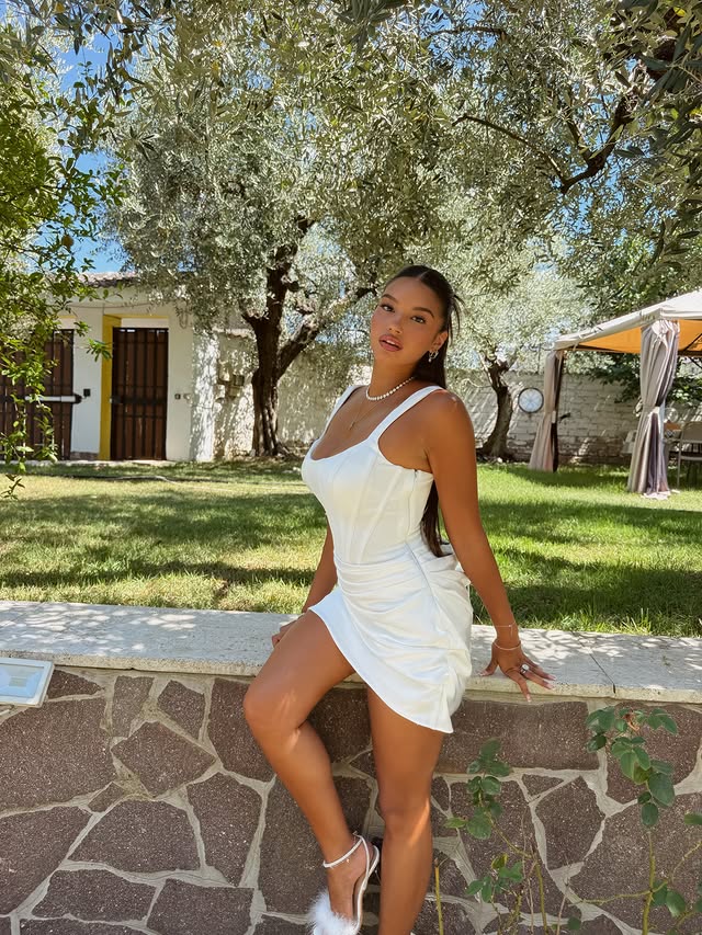 Instagram post by @patriziangiolie for Azazie. Caption reads: [...] & dressed in white 🤍☀️ wearing....