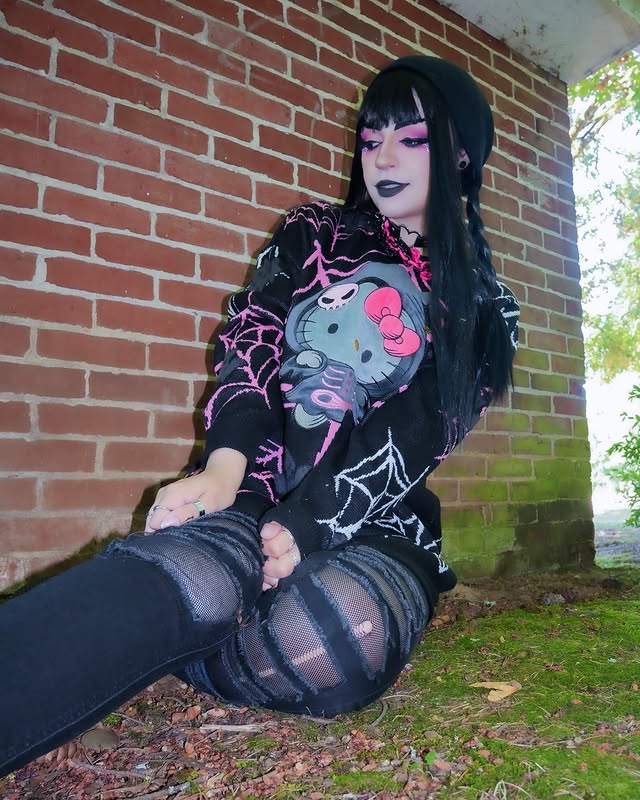 Instagram post by @nightmarekittykat for Hot Topic. Caption reads: [...] 😍』 Oversized Hello Kitty sweater from....