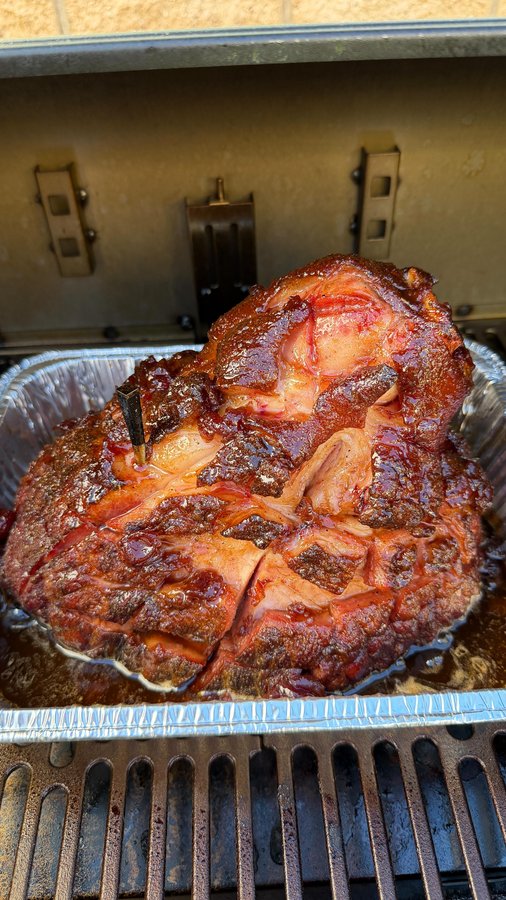 Instagram post by @cooking_with_fire___ for Oklahoma Joe's. Caption reads: Cherry Cola Glazed Ham on the @oklahomajoes Tahoma....