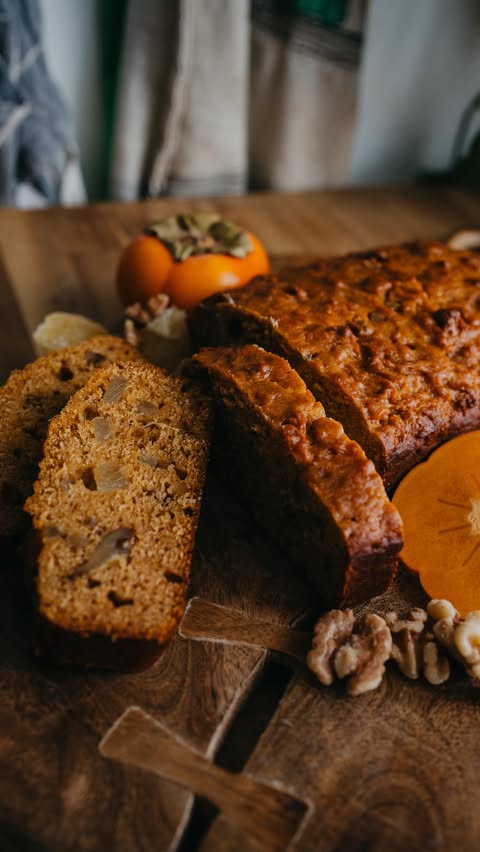 Instagram post by @modhippiehabits for Le Creuset. Caption reads: Spiced Persimmon Bread! Comment ‘persimmon bread’....