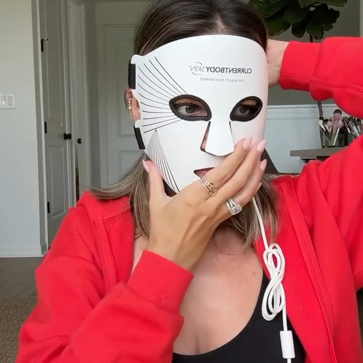 Instagram post by @nicolemasifilo for currentbody. Caption reads: Sienna is TERRIFIED of my red light mask....