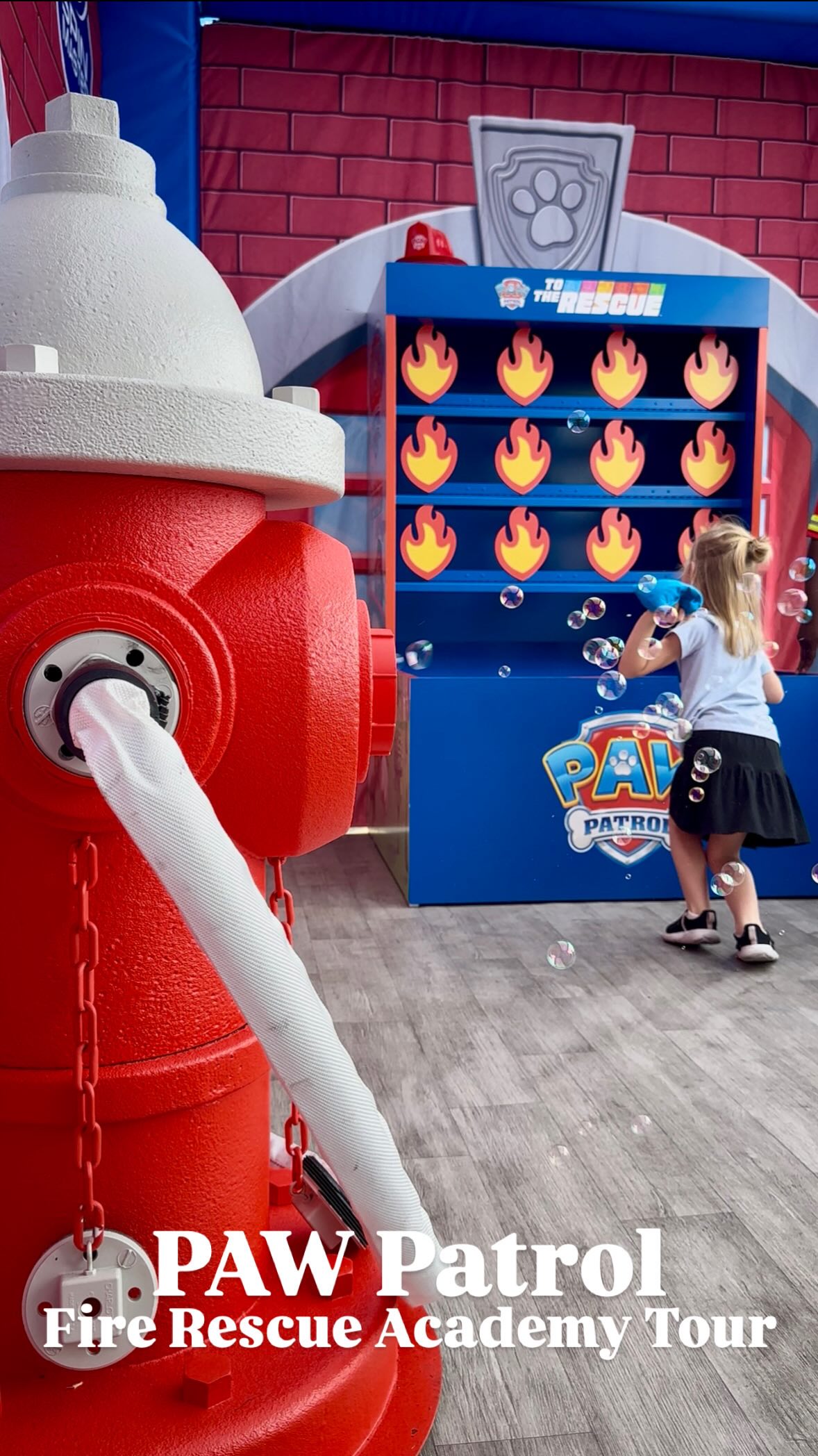 Instagram post by @kidsinkc for Spin Master. Caption reads: The PAW Patrol Fire Rescue Academy tour stopped by....