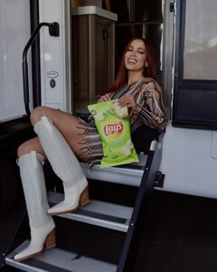 Instagram post by @anitta for Lay's. Caption reads: Lay’s is giving away 5 signed pairs of these....