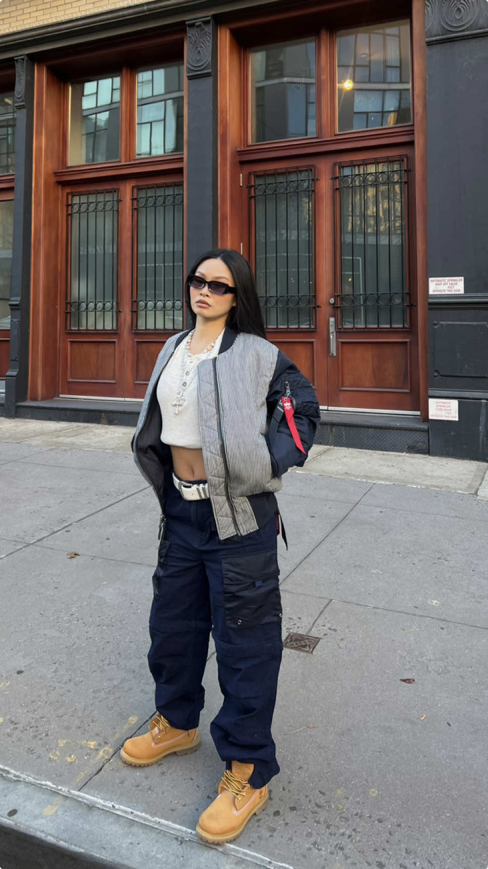 TikTok post by @jennylinnnn for Alpha Industries. Caption reads: styling my favorite pieces from @Alpha Industries....