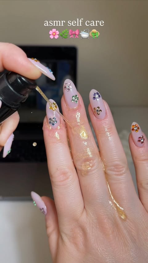 Instagram post by @katiesnails_ for L'OCCITANE en Provence. Caption reads: @loccitane almond shimmering oil & flower nails....
