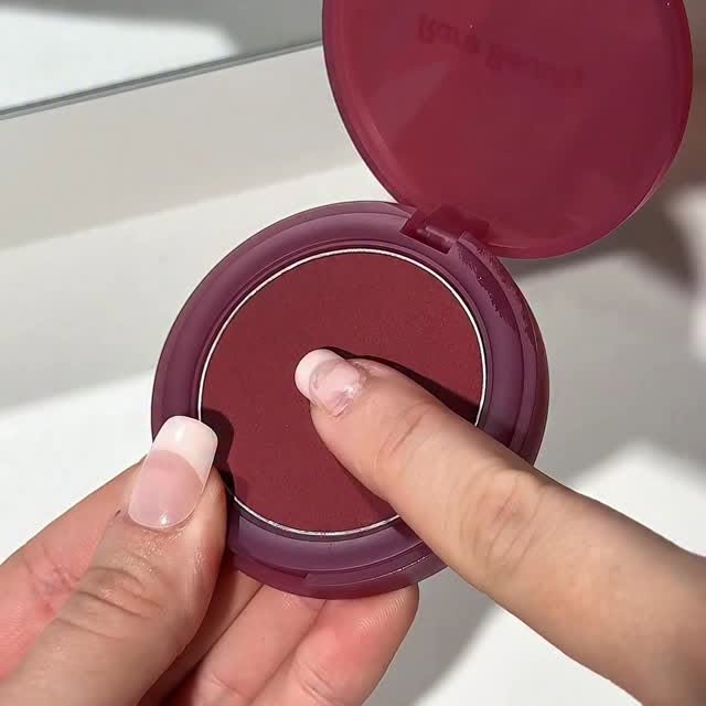 Instagram post by @_cloebeauty for Space NK. Caption reads: Bouncy berry blush ✨🫶🏻🎀 

The new @rarebeauty....