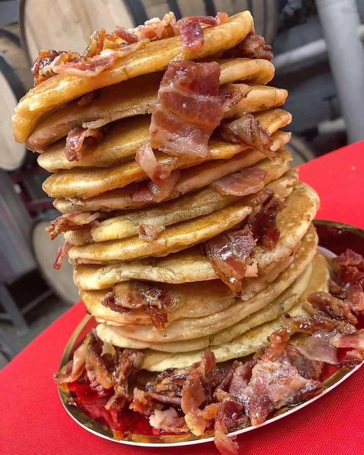 Instagram post by @eatmorebemore for Foodie Tribe. Caption reads: [...] 🥓 + 🥞  while hanging with @foodietribe,....