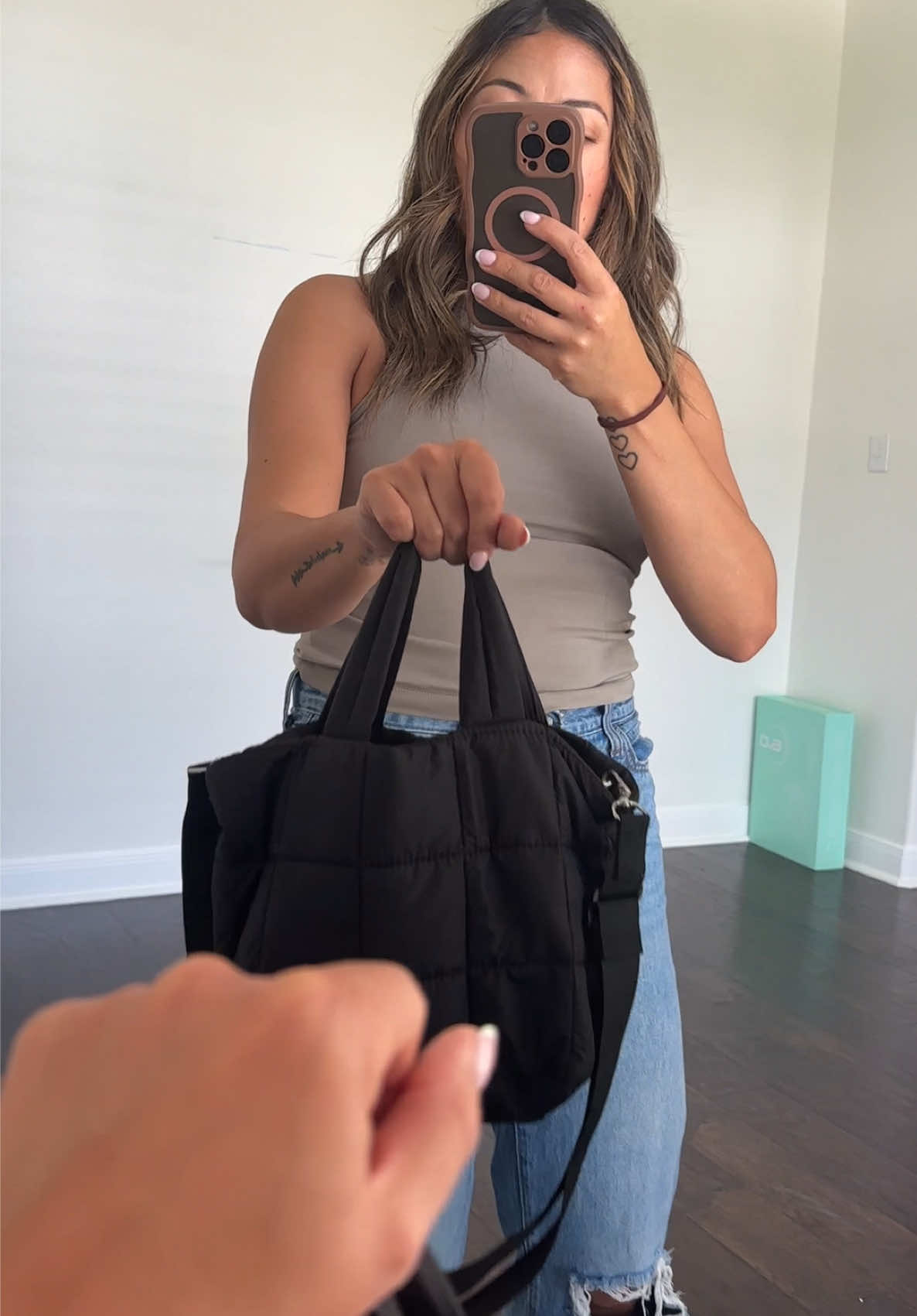TikTok post by @lizisliving1.0 for Westbronco. Caption reads: [...] my new everyday mini puffer tote from....