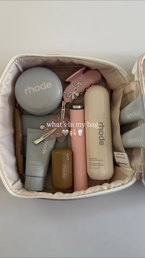 Instagram post by @carrieanne_ for Rhode Skin. Caption reads: what’s in my beauty bag! 🩶🩰🥛 @rhode....