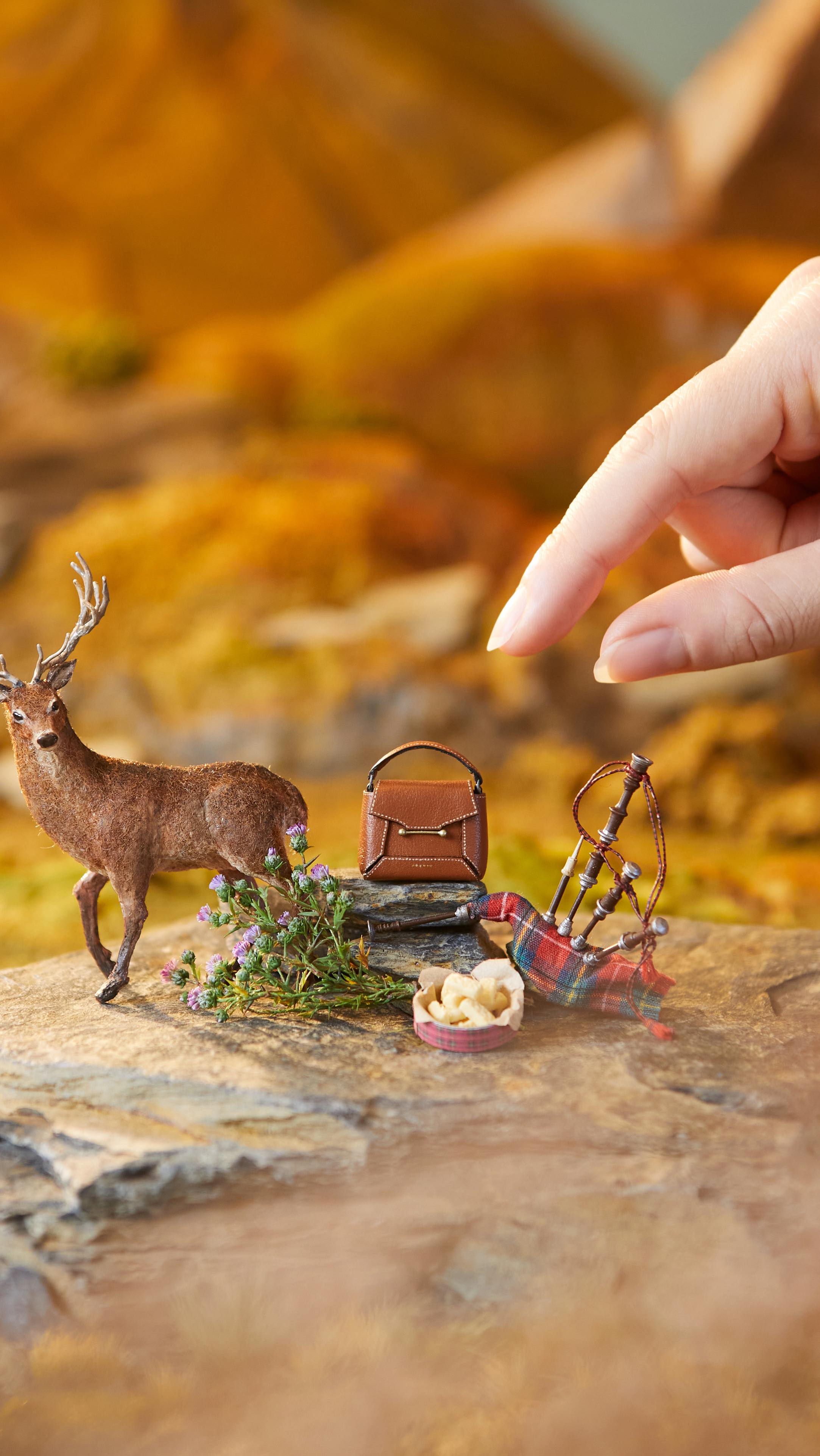 Instagram post by @hannahlemon_art for Strathberry. Caption reads: I enjoyed making this miniature Scottish scene for....