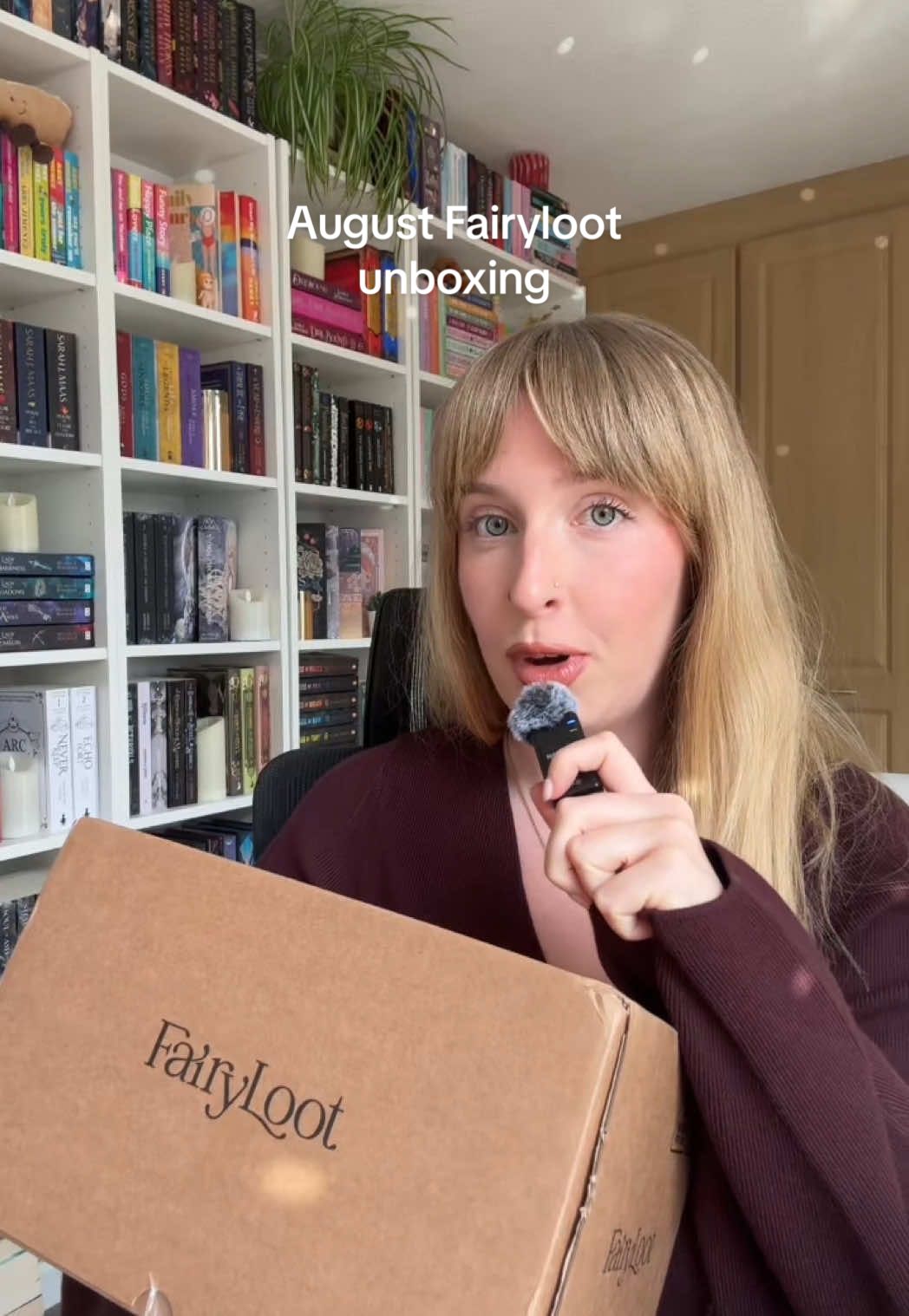 TikTok post by @whatemmyreads for FairyLoot. Caption reads: My August @FairyLoot unboxing 📚 Let's open some....
