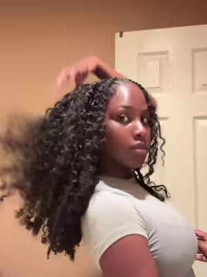 TikTok post by @thekennacole for Sterly Hair. Caption reads: This 20in Burmese Curly half wig from @sterlyhair....