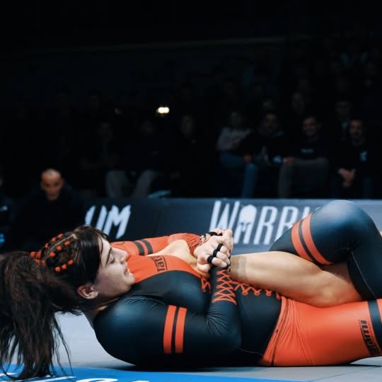 Instagram post by @bjj.worldtv for Timex. Caption reads: Relive the action! @helenajiujitsugirl's Polaris....