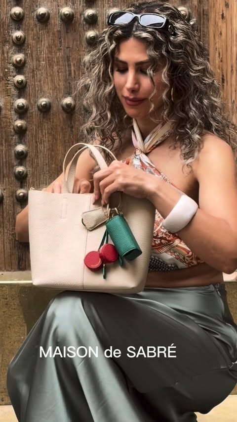 Instagram post by @styledby_eiva for MAISON de SABRÉ. Caption reads: City moments with my favorite bag @maisondesabre✨....