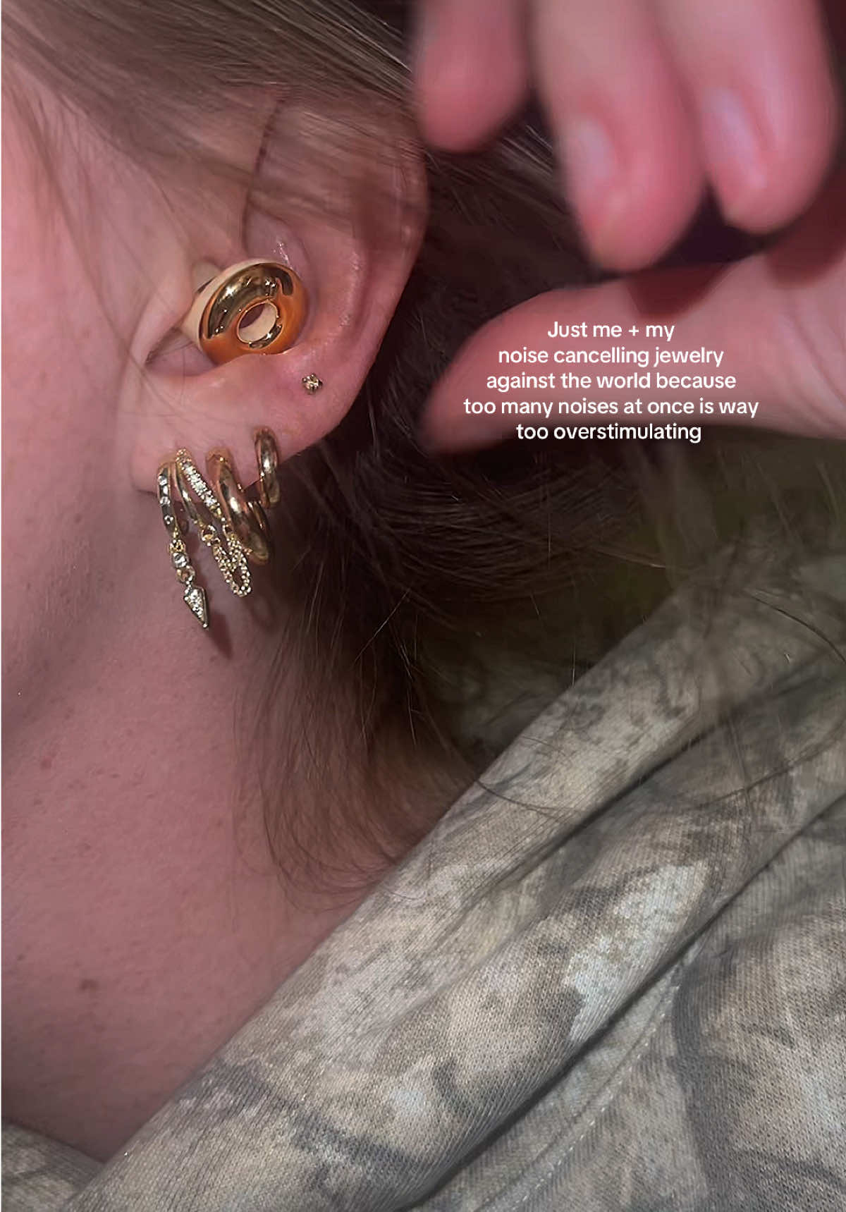 TikTok post by @stylebybrittxo for Loop Earplugs. Caption reads: [...] all the background noise @LoopEarplugs 🤌🏼✨....