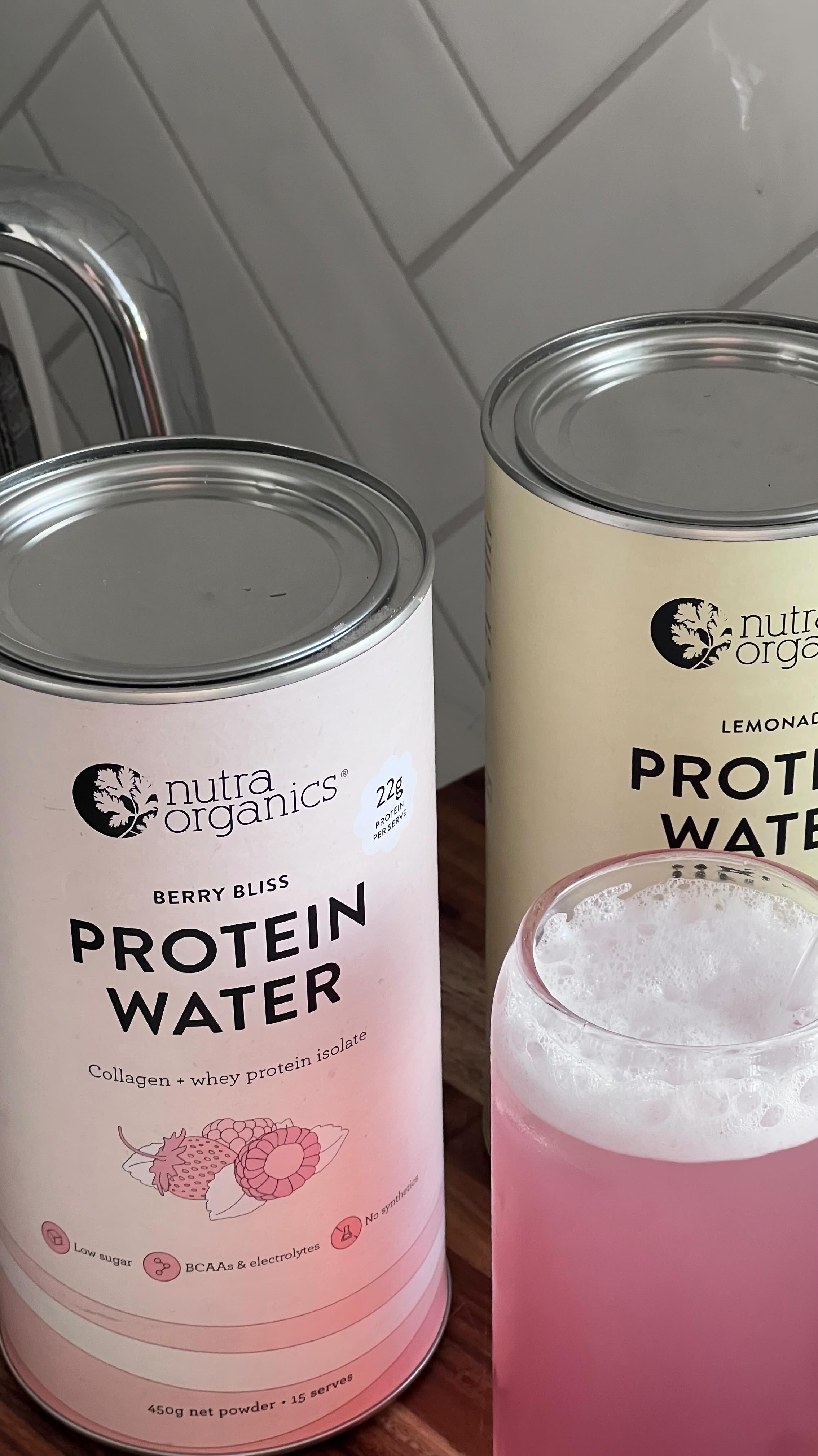 Instagram post by @michaelawebb for Nutra Organics. Caption reads: Testing out @nutraorganics protein water🍓🫐🍋 22g....