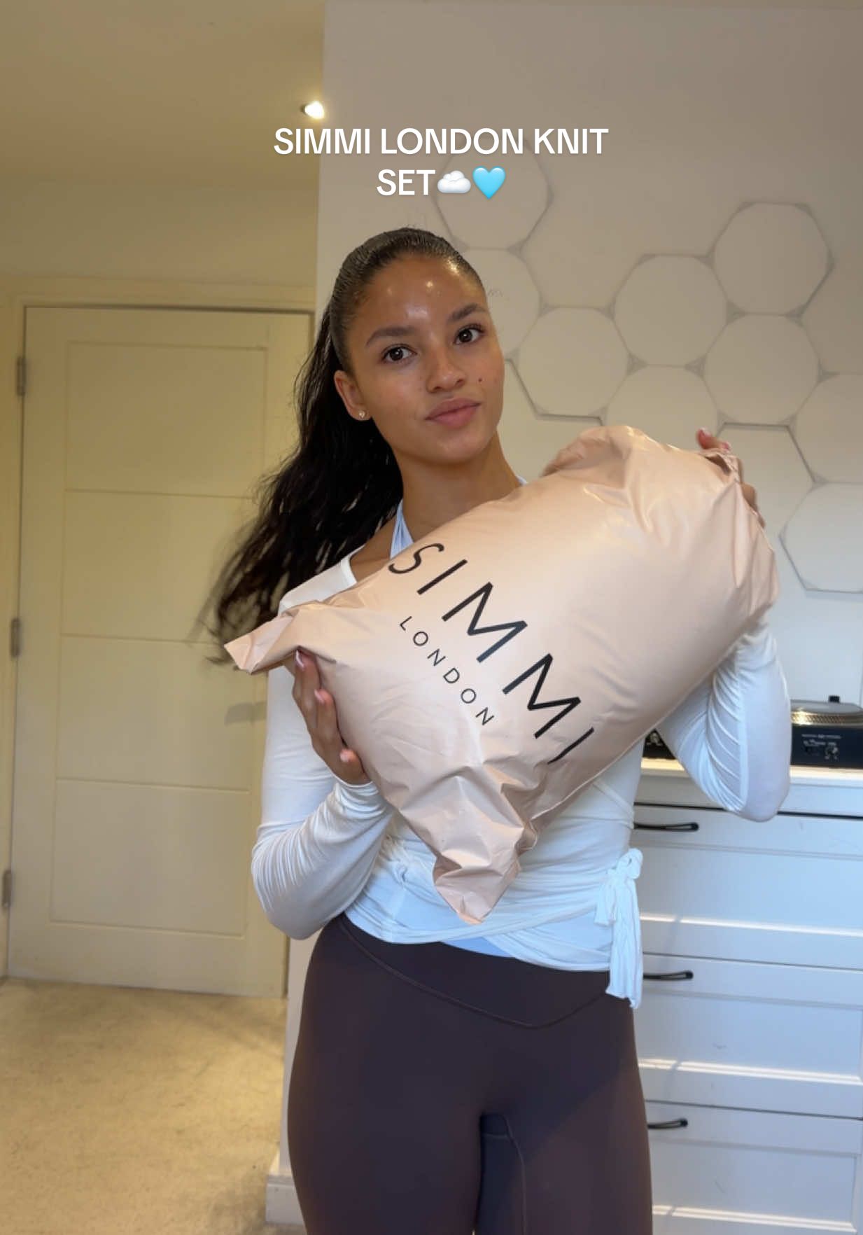 TikTok post by @tyrabaylis for Simmi London. Caption reads: [...] XS, you neeed to feel the quality!☁️....