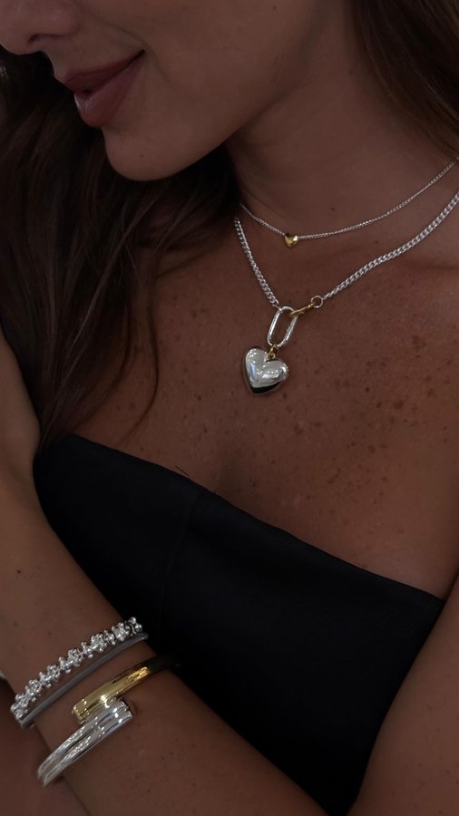 Instagram post by @rivadeneirak for TOUS. Caption reads: 🖤🔗✨
Only @tousjewelry.