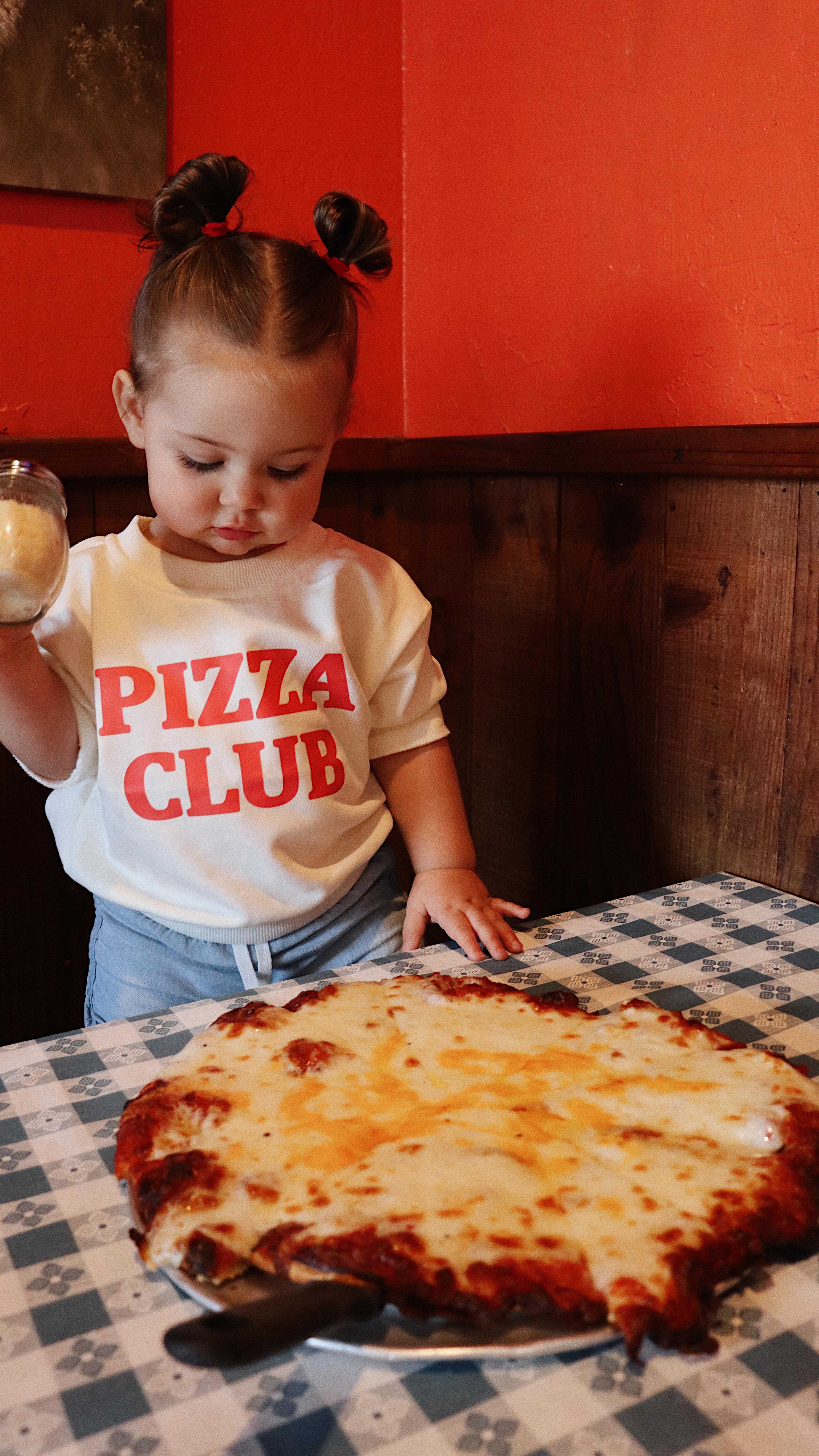 Instagram post by @jacqueline_taylor_wilson for MiniOlie. Caption reads: Just a girl, her pizza, and a shirt that says it....