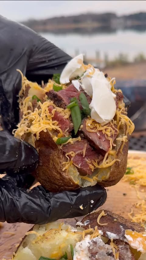 Instagram post by @grubwithjus for Kingsford. Caption reads: Smoked Steak Baked Potatoes @kingsford Style)....