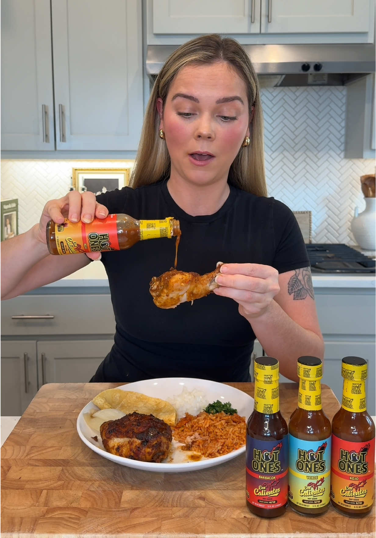 TikTok post by @taryneliseee for HEATONIST. Caption reads: Hot Ones sauces are now at many H-E-B stores....