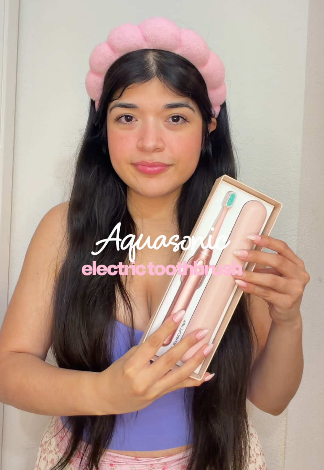 TikTok post by an influencer for AquaSonic. Caption reads: Such a good toothbrush 🎀✨ @AquaSonic #aquasonic....