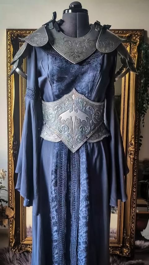 Instagram post by @thescarletthuntress for HolyClothing. Caption reads: Every lady knight needs her armor 🗡️ Leatherwork....