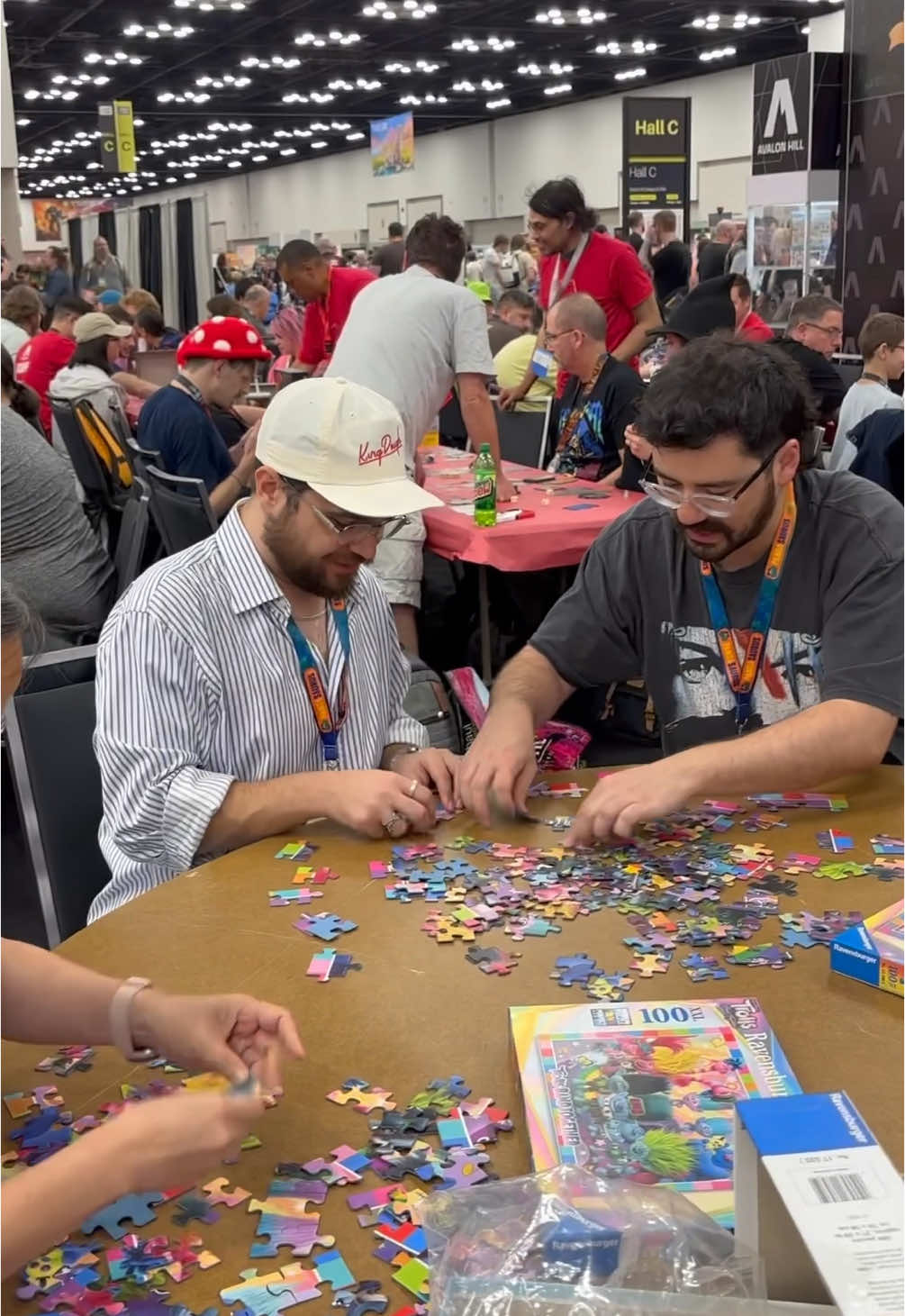 TikTok post by @goodgamesmorley for Ravensburger. Caption reads: speed puzzle world champ finals gencon 2025....