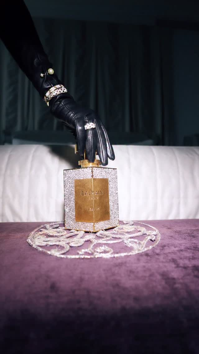 Instagram post by @marissa_everhart for Balmain. Caption reads: Dripping in Balmain, wrapped in fur, seated in....