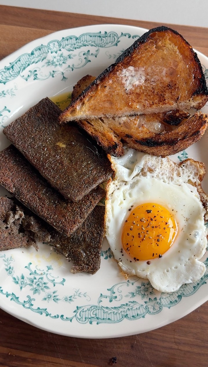 Instagram post by @noahtanen for Food52. Caption reads: Day 2, and the Scrapple’s ready. Crispy on the....
