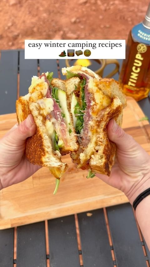 Instagram post by @the_adventureaddicts for TINCUP Whiskey. Caption reads: Brie prosciutto panini & @tincupwhiskey hot toddy....