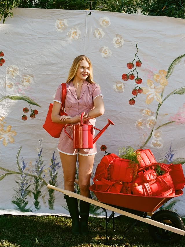 Instagram post by @amelia.edmondson for CALPAK. Caption reads: Garden bounty @calpak 🍅🪏🫛🌱🌞🫜 #ad.